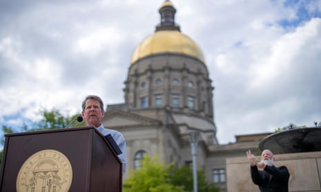 Georgia’s governor, Brian Kemp, speaks outside the state capitol building in Atlanta, Georgia, on 13 April. 