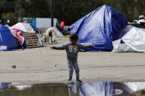 A displaced girl plays near a puddle in Beirut.