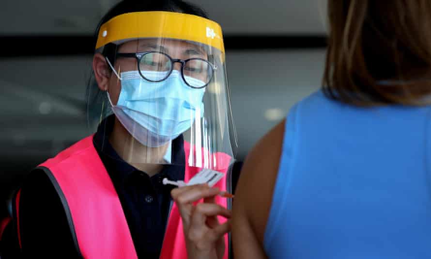 A nurse at Qudos Bank Arena in Sydney administers a Pfizer Covid-19 vaccine.