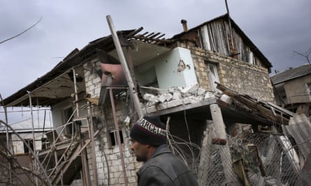 An ethnic Armenian man walks past a destroyed house in Nagorno-Karabakh in April.