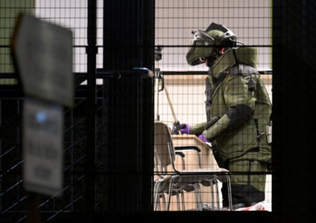 A member of a bomb disposal team works inside the building at the Jehovah's Witness church