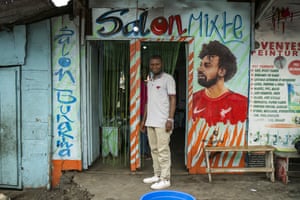 Idris, 32, poses in front of his hairdressing salon in Goma, Democratic Republic of Congo