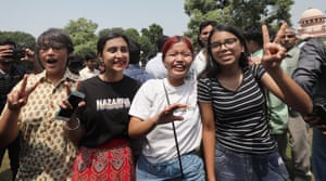 Members of the lesbian, gay, bisexual, and transgender community react outside the supreme court