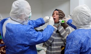 Medics perform an examination on a rescued Syrian refugee in the Iskele district (Trikomo) in the self-declared Turkish Republic of North Cyprus recognised only by Turkey, north of Famagusta, on 21 March 2020.