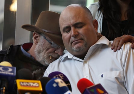Mexican writer and activist Javier Sicilia, left, comforts Julian LeBarón, who lost relatives and friends in the November 2019 ambush in northern Mexico, during a press conference in Mexico City, on 9 January.