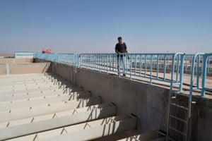 Engineer Khaled Abdaljabr at al-Himma water station looks at an empty pool that used to purify water for Hasakah