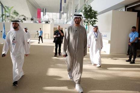 President Sultan Ahmed Al Jaber walks in through the summit, after a second draft of a negotiation deal was released.