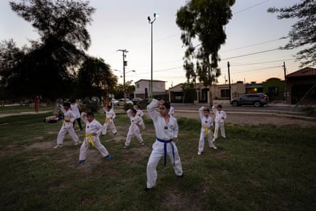 Children take part in a taekwondo class after the sun set on a day that saw temperatures beyond 115F, on 19 July 2023, in Mexicali, Mexico.