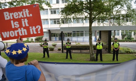 Police officers watch protesters as Boris Johnson arrives at West Midlands Police’s learning and development centre, Birmingham.