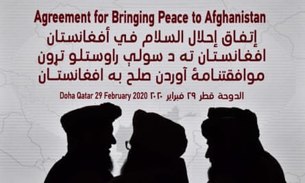 Members of the Taliban delegation gather ahead of the signing ceremony with the US in Doha, Qatar, on 29 February.