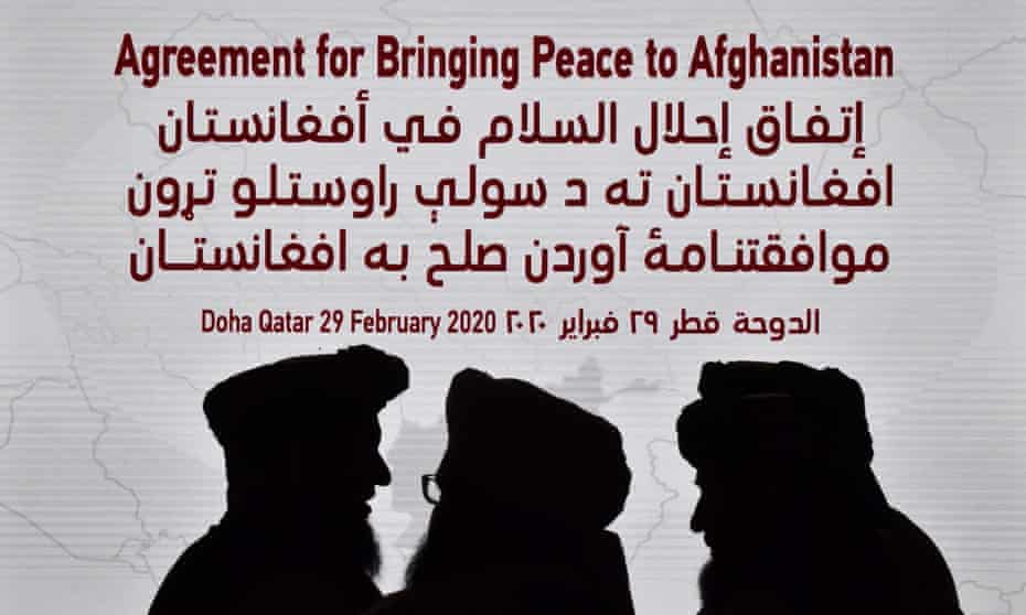 Members of the Taliban delegation gather ahead of the signing ceremony with the US in Doha, Qatar, on 29 February. 