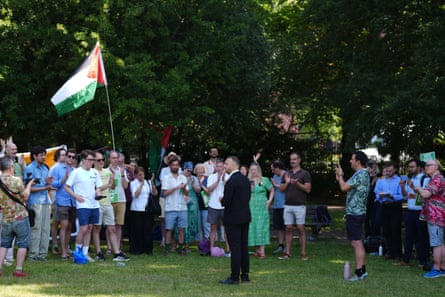 A Green rally in a London park attended by Polanski with a Gaza flag flying
