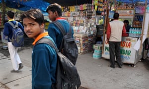 Students walked past a tobacco kiosk opposite the main gates of ASN Senior Secondary School in New Delhi, India.