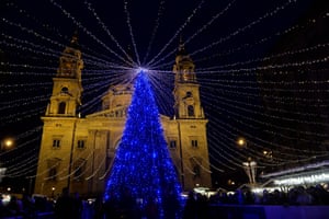 A Christmas tree is lit up in front of the Basilica of St Stephen in Budapest, Hungary