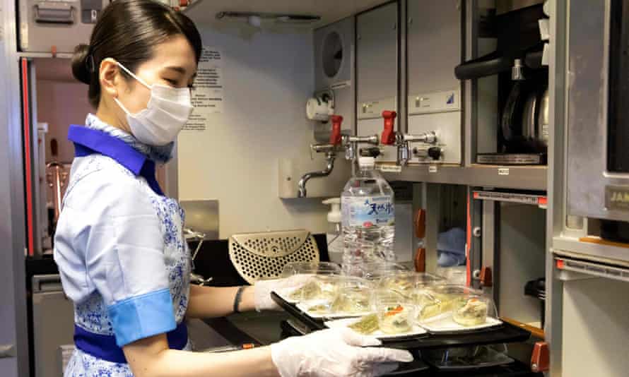 An All Nippon Airways flight attendant prepares food for ‘flyers’ on a parked plane at Haneda airport.