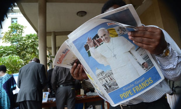 A man reads a newspaper bearing an image of Pope Francis in Nairobi