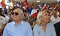 The party’s co-founder Jean-Marie Le Pen (left) and his daughter Marine Le Pen, its current leader (right) pictured in 2014, sat side-by-side in a room filled with people waving French flags