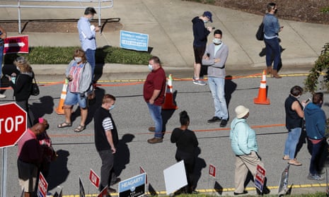 Voters wait in line in Cary, North Carolina on 15 October 2020.