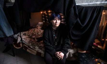 Maryna Drasbaieva seated on the bottom bunk in a room