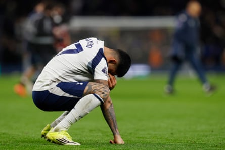 Cristian Romero on his haunches, one hand to his eyes, after Tottenham’s 2-1 defeat by West Ham