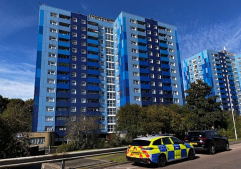 block of flats in Leabank, Luton, police car to the fore