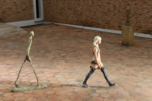 A Giacometti sculpture and a model on the runway at the Louis Vuitton 2019 Cruise collection