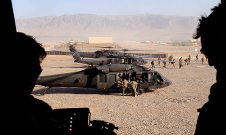 Troops landing in a helicopter in Afghanistan