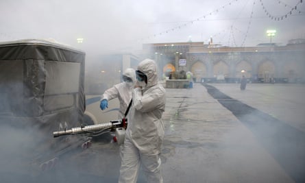 Members of a medical team spray disinfectant at Imam Reza’s shrine in Mashhad, Iran