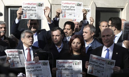 Journalists and politicians hold copies of the opposition Cumhuriyet newspaper in Istanbul.