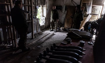 Ukrainian soldiers wait for firing orders next to mortar shells in their fighting position near Chasiv Yar.