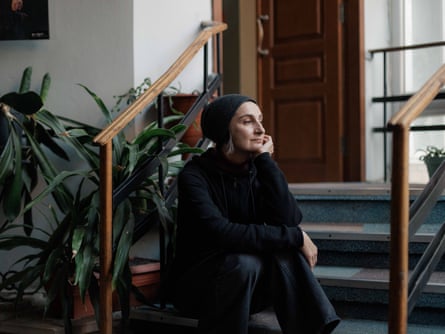 Oksana Dmitrieva sitting on a step looking pensive