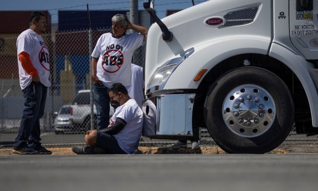 Independent truck drivers gather to delay the entry of trucks at a container terminal at the Port of Oakland.