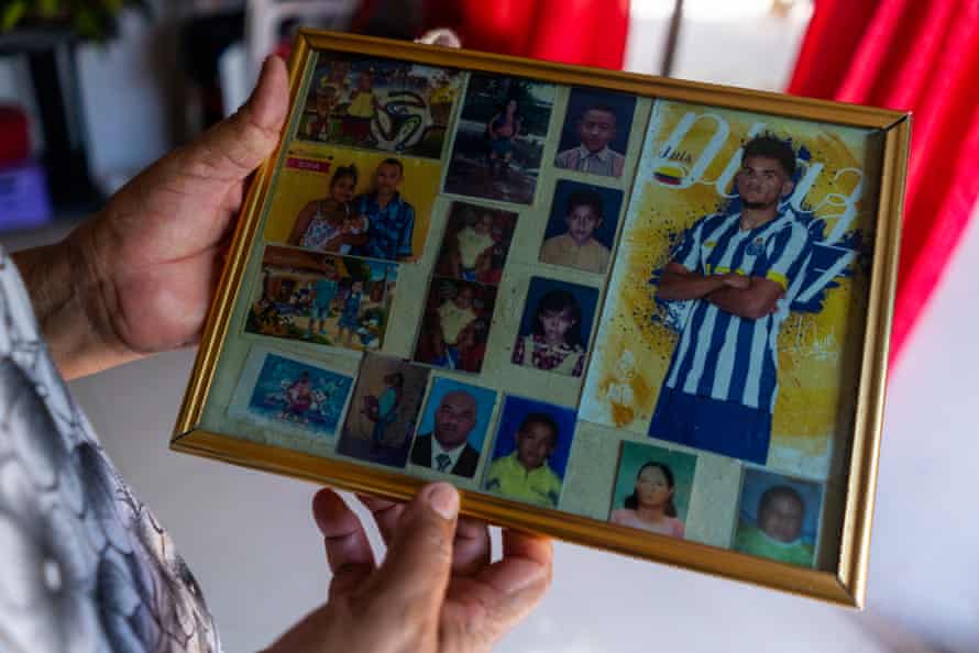 Carmen Pérez, one of Díaz's aunts, shows off family photographs including one that her nephew had given her when he was still playing for FC Porto in Portugal.