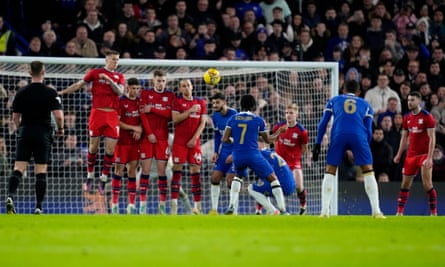 Raheem Sterling’s bends his free-kick over the wall to extend Chelsea’s lead.