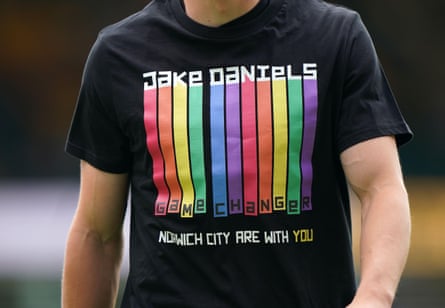 A Norwich City player wears a rainbow t-shirt reading “Jake Daniels, Norwich City are with you”