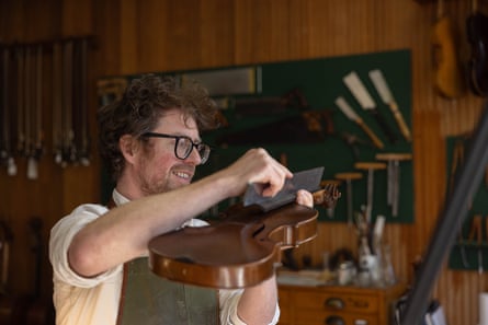 Martin Paul works on a violin in his Melbourne workshop