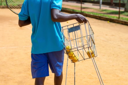David Tyaba refills a basket of tennis balls during a coaching session at Makerere University Guest House