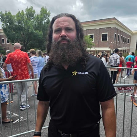 A man in a black polo shirt.