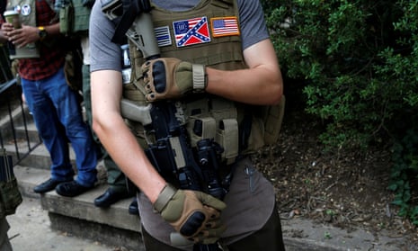 A member of a white supremacists militia stands near a rally in Charlottesville, Virginia in August 2017.