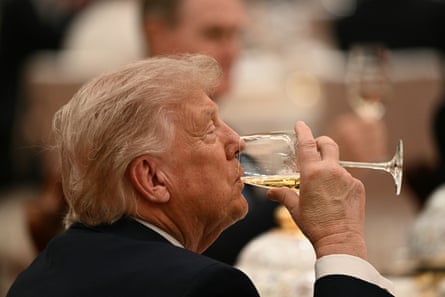 Donald Trump drinks as he attends a state banquet with Xi Jinping.