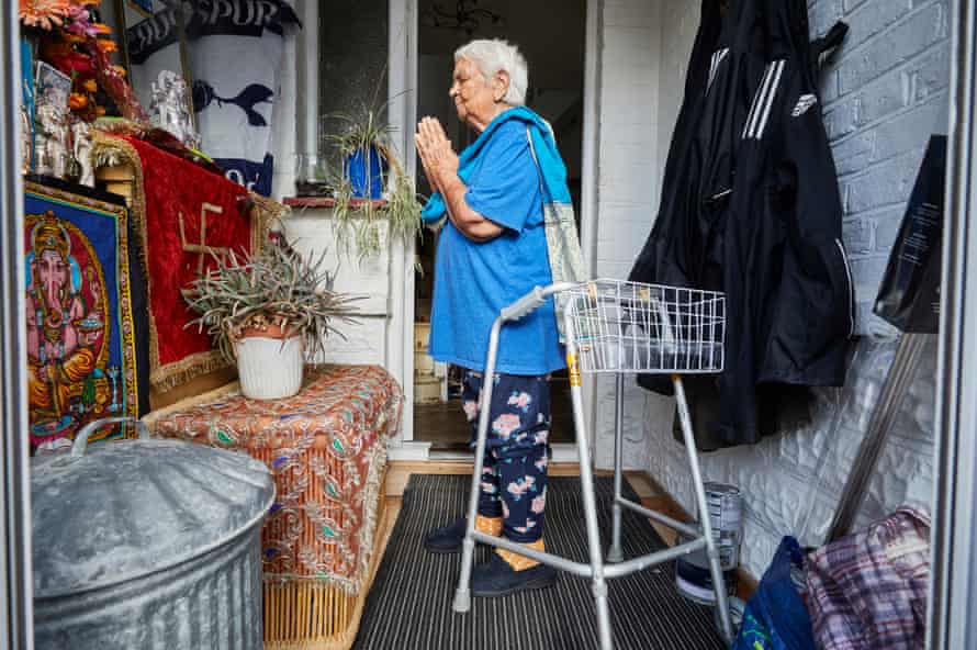 24 May: Pushpa Chaudhary, 85, prays to a Hindu shrine in her porch at home in Southall, London