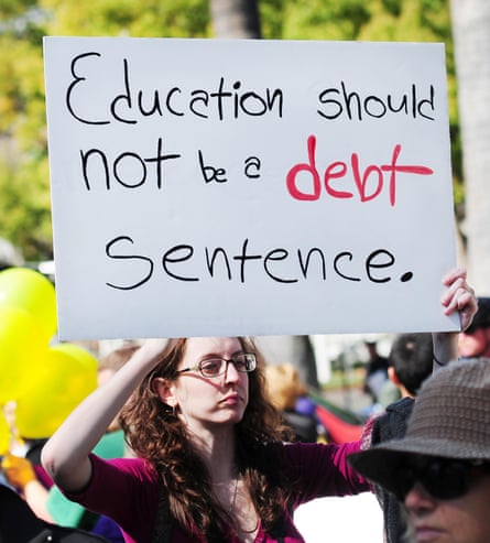 A young activist holding a sign at a protest against annual tuition hikes.