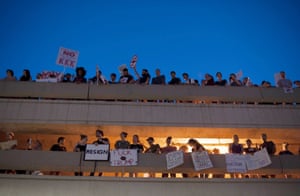Protesters line a parking garage outside the Convention Center