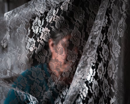 An unidentified woman with her face obscured by lace material