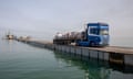 a truck drives across a pier