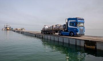 a truck drives across a pier