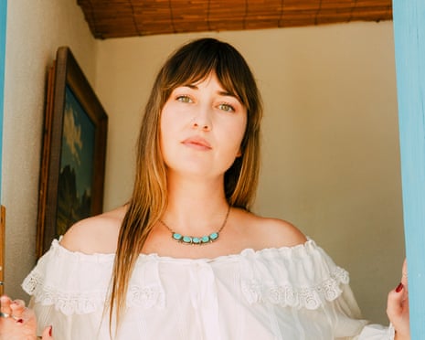 Jess Williamson looks at the camera wihle standing in a doorway