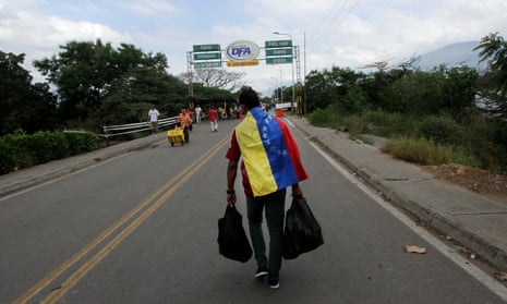 A man crosses the Francisco de Paula Santander international bridge, linking Urena, in Venezuela and Cucuta, in Colombia.
