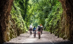 A family cycles on the Strawberry Line, part of the National Cycle Network route 26, at Shute Shelve Tunnel near Axbridge in Somerset.<br>2CE88HH A family cycles on the Strawberry Line, part of the National Cycle Network route 26, at Shute Shelve Tunnel near Axbridge in Somerset.