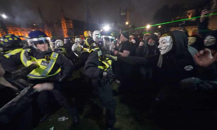 Police confront protesters in the Million Mask March in Parliament Square